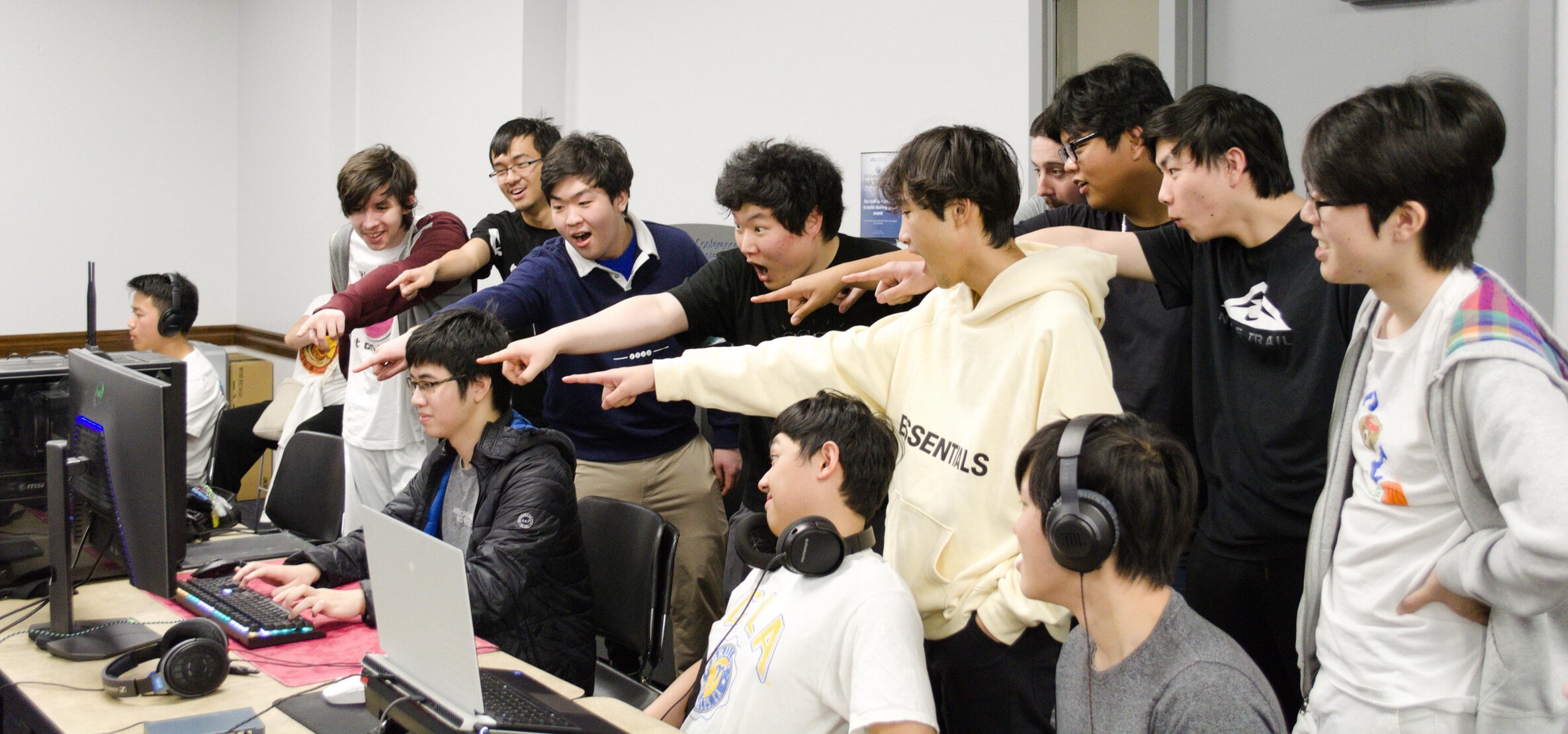 Photo of people pointing toward a player's monitor